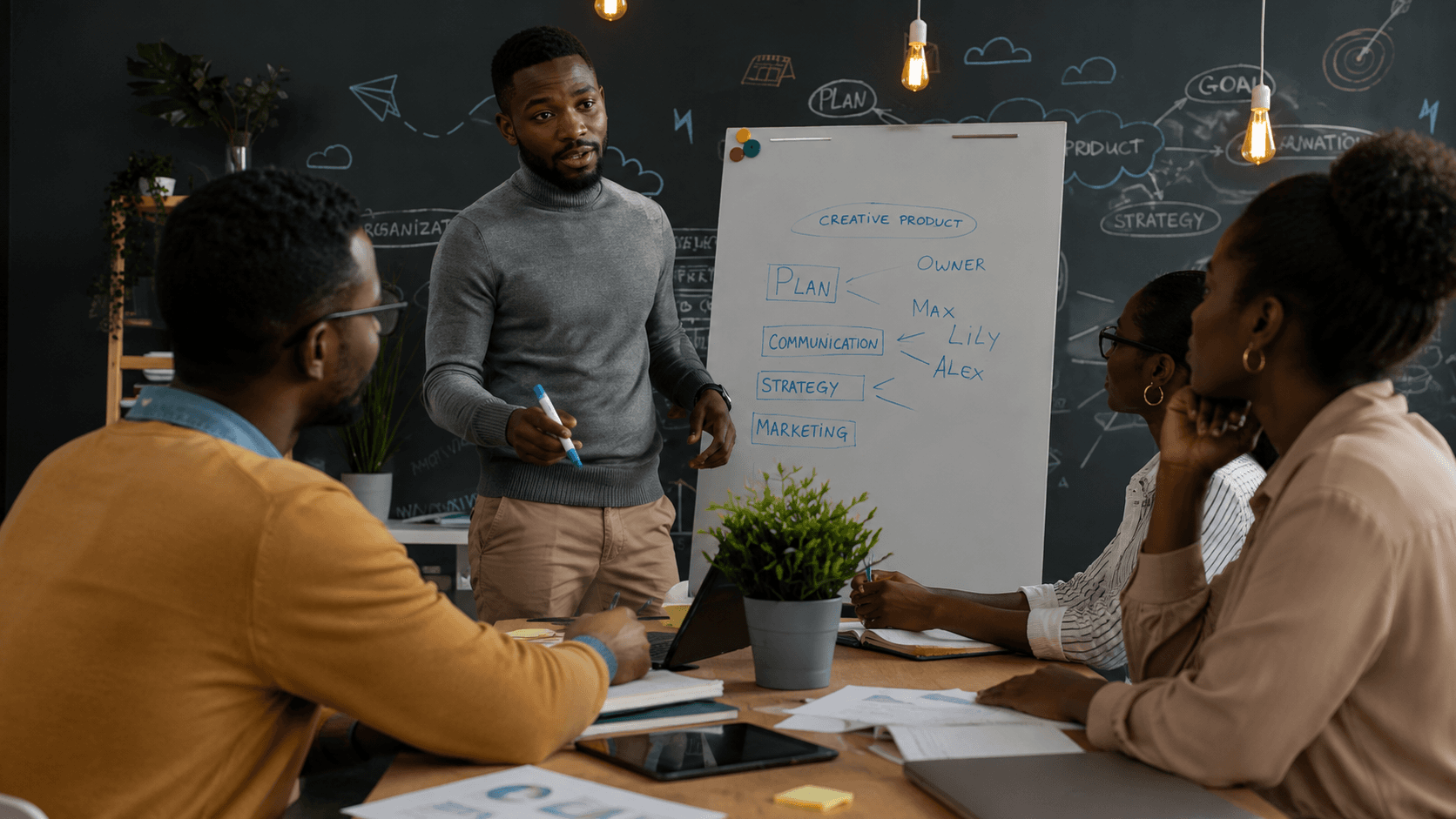 Consultants collaborating around a whiteboard during a strategy session
